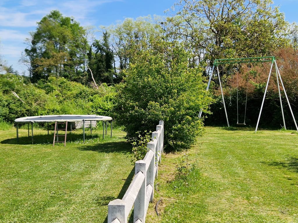 Trampoline and swing frame in the walled garden