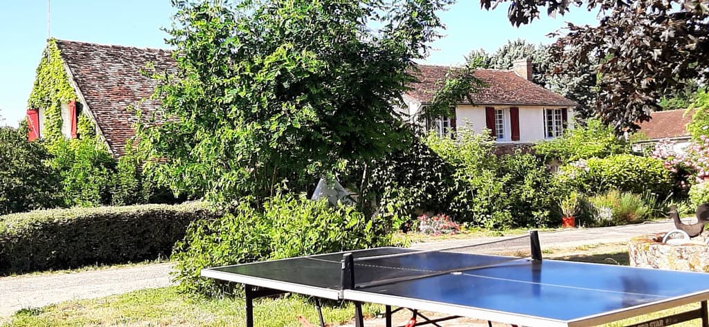 Table tennis table in the garden, with the house in the background