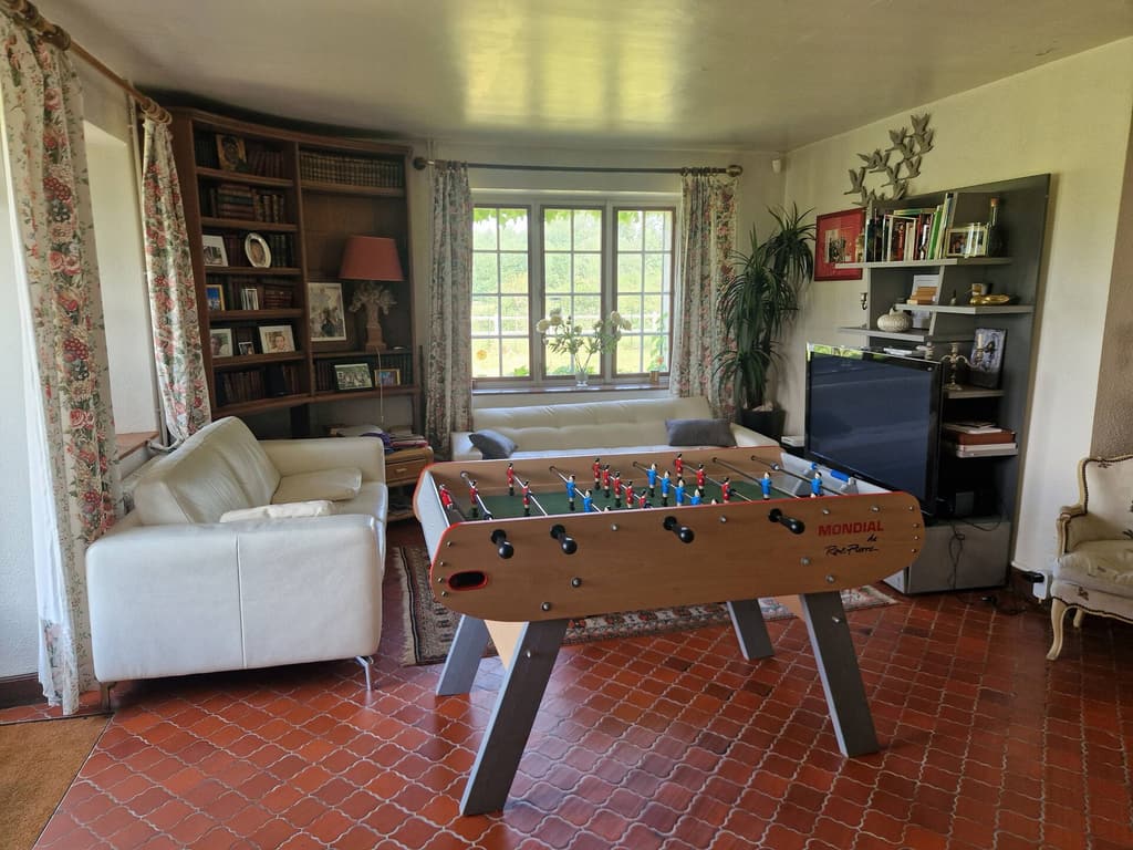Table football in the library, a window onto the garden and a white sofa